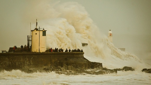 Waves break over Porthcawl harbour, south Wales, as the region continues to be battered high winds and heavy rain.