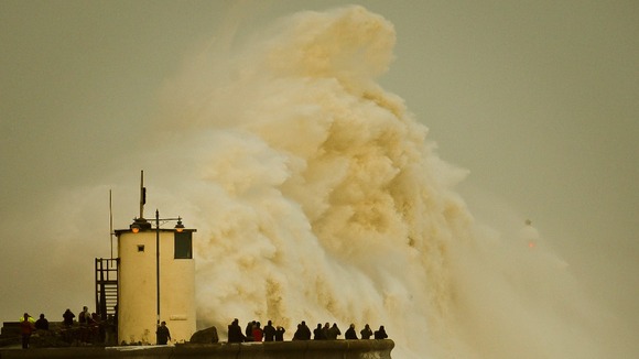 Waves break over Porthcawl harbour.
