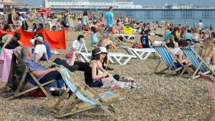 People enjoy the warm weather on Brighton beach