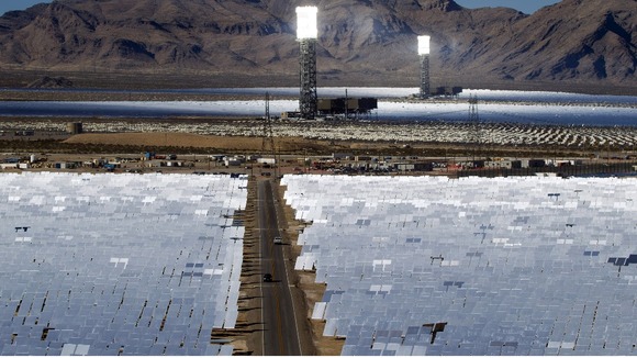Heliostats reflect the sunlight onto boilers in towers at the opening of the Ivanpah Solar Electric Generating System.