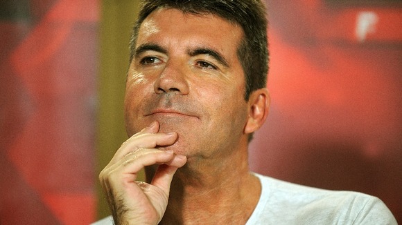 Simon Cowell has flown to New York to be with his pregnant partner