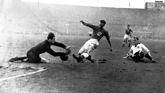 West Germany goalkeeper Fritz Herkenrath saves at the feet of England's Tom Finney