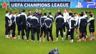 Manchester city team standing in a circle.