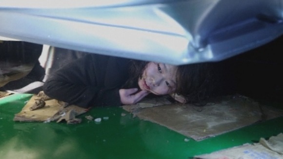 A woman is trapped under debris.