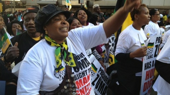 Protesters gather outside the court in South Africa with placards which read 'we say no to abuse of artistic expression'