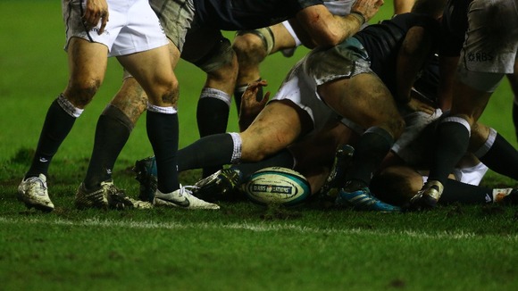 Men playing rugby