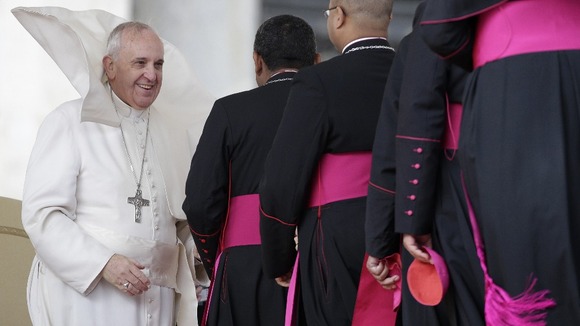 The Pope greeted cardinals in the windy weather.