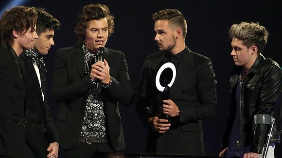Harry Styles takes the mic after eventually making his way on stage.