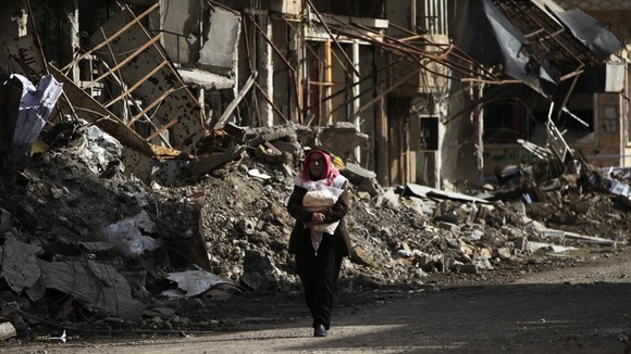 A man walks along a damaged street in Deir al-Zor, eastern Syria, earlier this week.