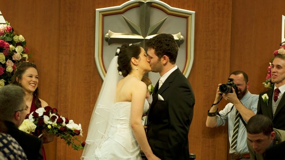 The couple share their first kiss as man and wife.