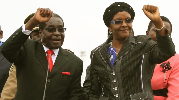 Zimbabwean President Robert Mugabe and his wife Grace wave to the crowd.