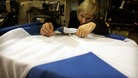 Seamstress Tracey Watt from Flags and Banners in Baillieston near Glasgow, putting the finishing touches to a Saltire Flag,