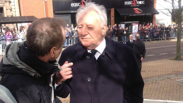Former Manchester United boss Tommy Docherty outside as crowds await the arrival of Sir Tom Finney's cortege