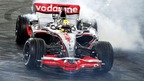 Lewis Hamilton performs a donut in his F1 car