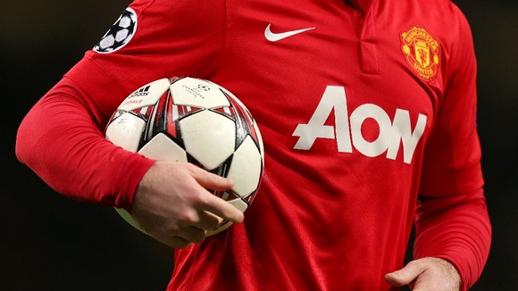 Manchester United's Wayne Rooney holds an official UEFA Champions League match ball.