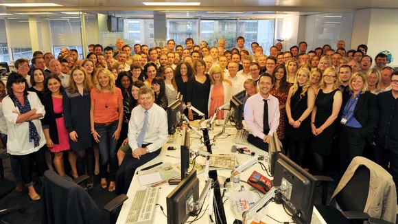 The News Of The World editor, Colin Myler (FRONT L), poses with the staff of the newspaper the day before its planned closure