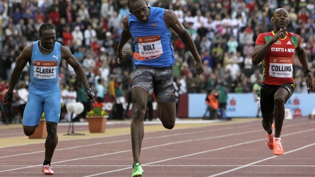 Usain Bolt crosses the finish line in the 100 meters men's race at the IAAF World Challenge