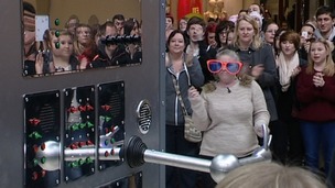 A performer dons some silly glasses in a bid to land the prize.