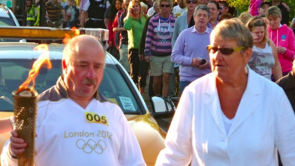 Blind man carrying torch