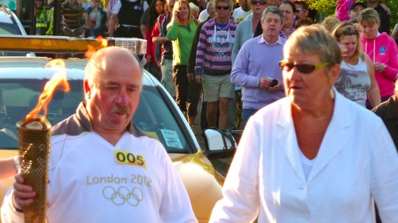 Blind man carrying torch