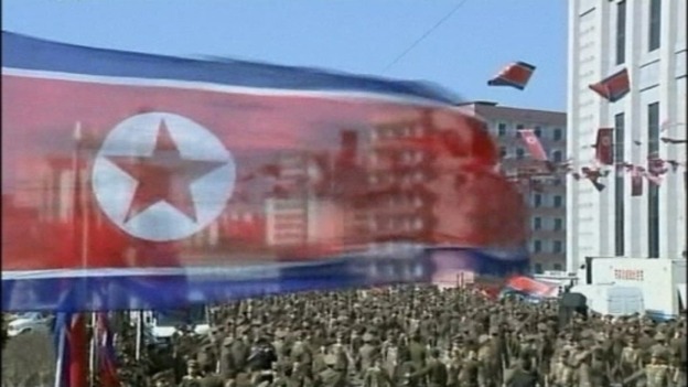 A North Korean flag is seen above the amassed crowds