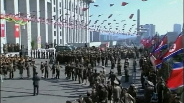Flags fly overhead as supporters dance in formation