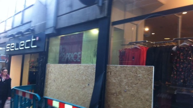 Boarded up shop where fire took place
