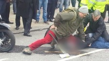 Axe-wielding robber wrestled to the ground by passer-by