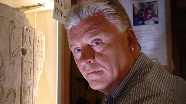 File photo of Derek Acorah examines hieroglyphics on a stone tableau at the Petrie Museum of Egyptian Archaeology in central London.