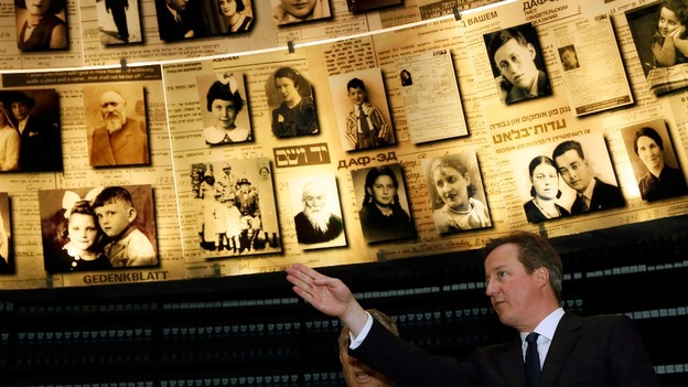 David Cameron looks at pictures of Jewish people killed in the Holocaust during a visit to the Yad Vashem's Holocaust History Museum.