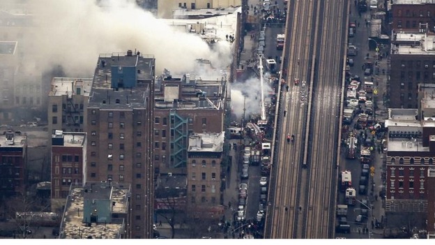 Smoke billows from the site of a building collapse