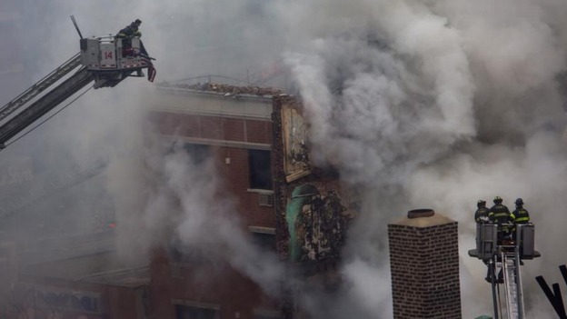 New York City firefighters examine the rubble