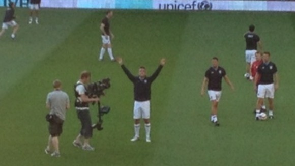 Robbie Williams salutes the fans as Soccer Aid gets underway at Old Trafford