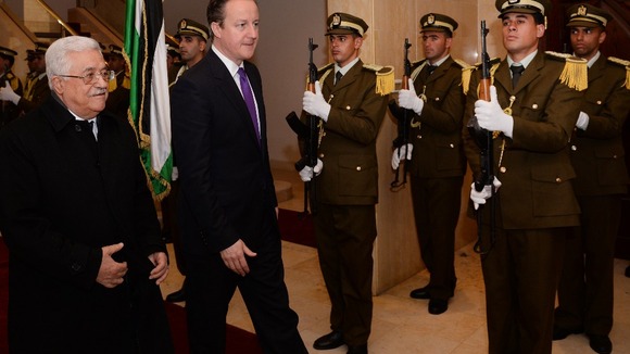 David Cameron walks with Palestinian president Mahmoud Abbas during his visit to the region