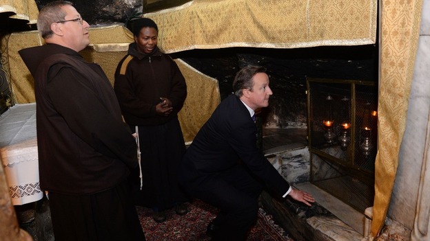 David Cameron looks into the manger where it is believed Jesus Christ was born in the crypt of the Church of the Nativity in Bethlehem.