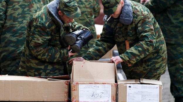 Members of a pro-Russian self defence unit pick up boots after an oath swearing ceremony to the Crimea regional government.