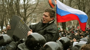 A pro-Russian demonstrator scuffles with police during a rally in Donetsk.