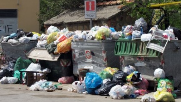 Piles of rubbish lie on a street in Cefalu in Italy