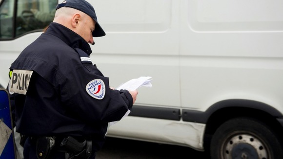 French police officers control cars with number plates ending in even numbers.