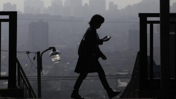 A woman uses her phone in South Korea
