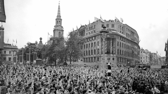 A crowd gathered in Trafalgar Square, London, to get a glimpse of the Queen's coach as it passed in procession for the Coronation