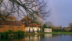 rainbow behind flooded cricket pitch