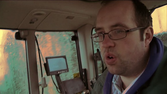 CU man in tractor cab