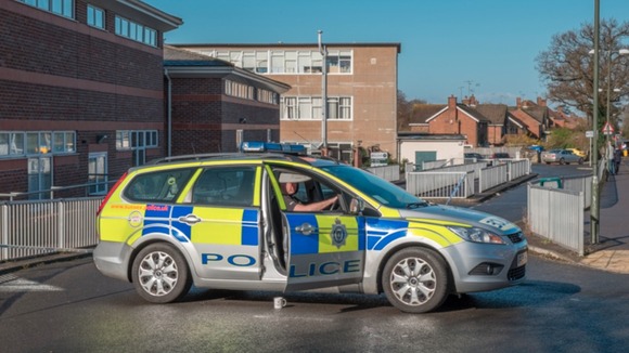 A police car outside Millais School in Horsham
