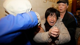 A family member cries after watching the Malaysian Prime Minister's press conference.