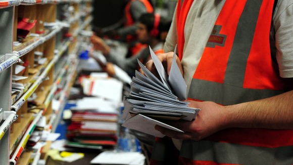 Royal Mail staff sort post.