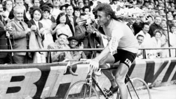 Jacques Anquetil performs a lap of honour around the Parc des Princes velodrome after winning his second Tour