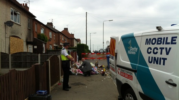 Flowers and tributes are removed from the house