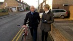 Julie Etchingham talking to man as walk along street