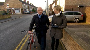 Julie Etchingham talking to man as walk along street
